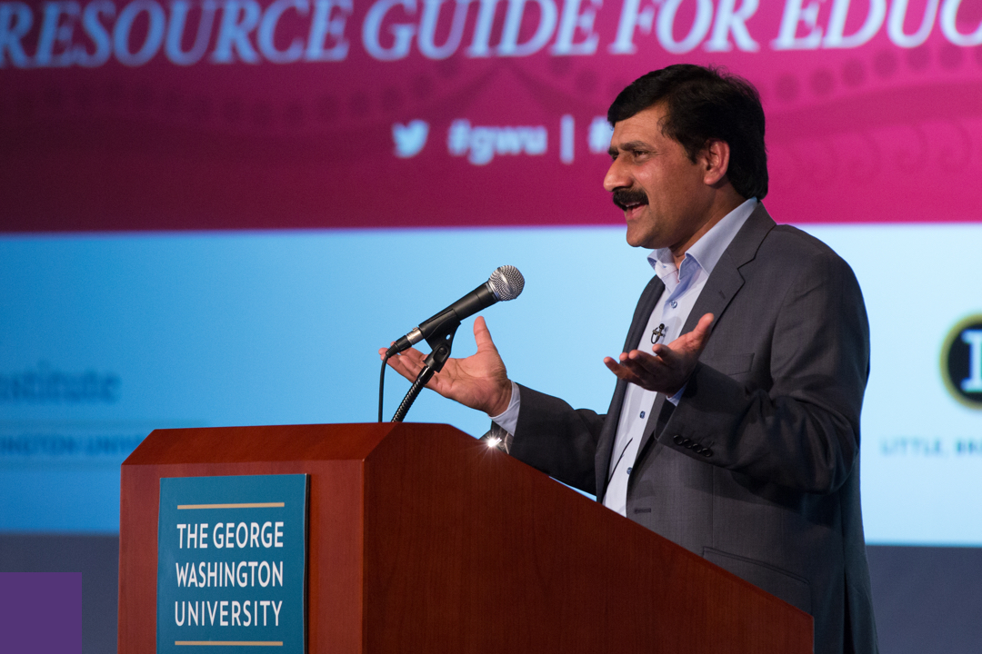 Ziauddin Yousafzai speaking at a podium