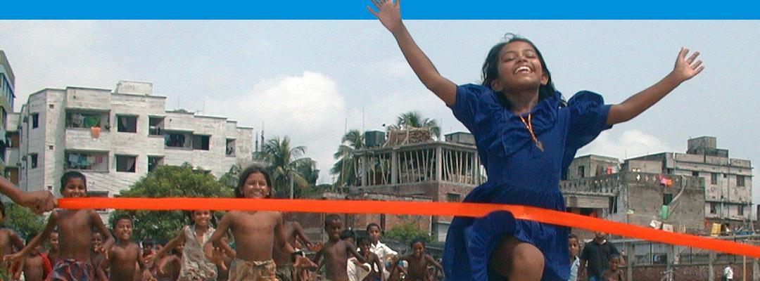 Girl running through a finish line